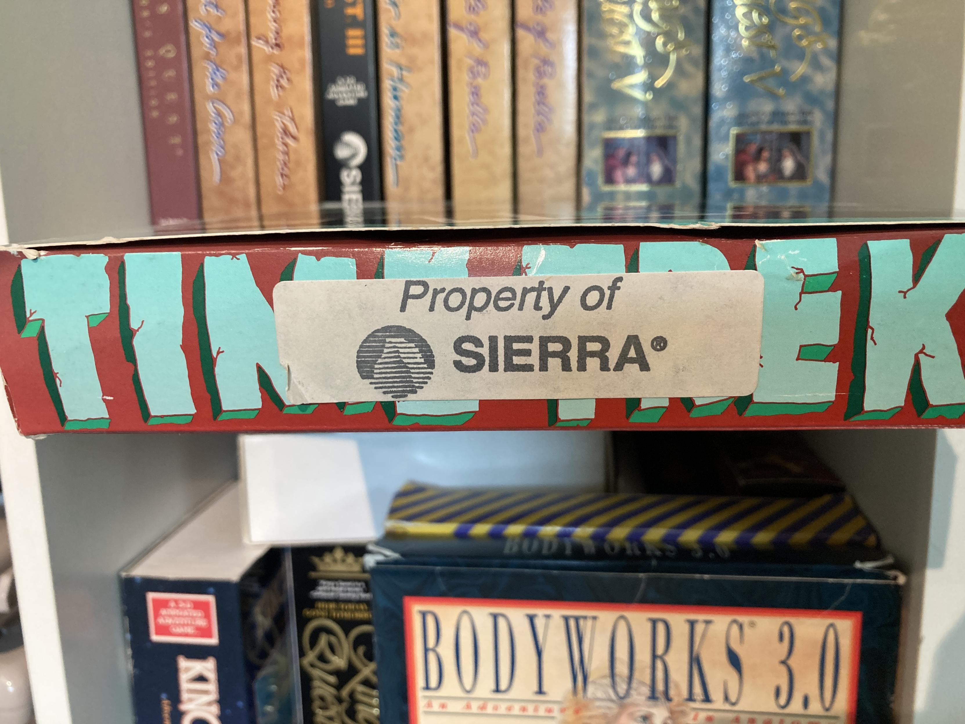 The bottom flap of Time Treks. it has a diskette label that has been stamped with a dark grey stamp that reads Property OF SIERRA, with the Half Dome logo beside it.