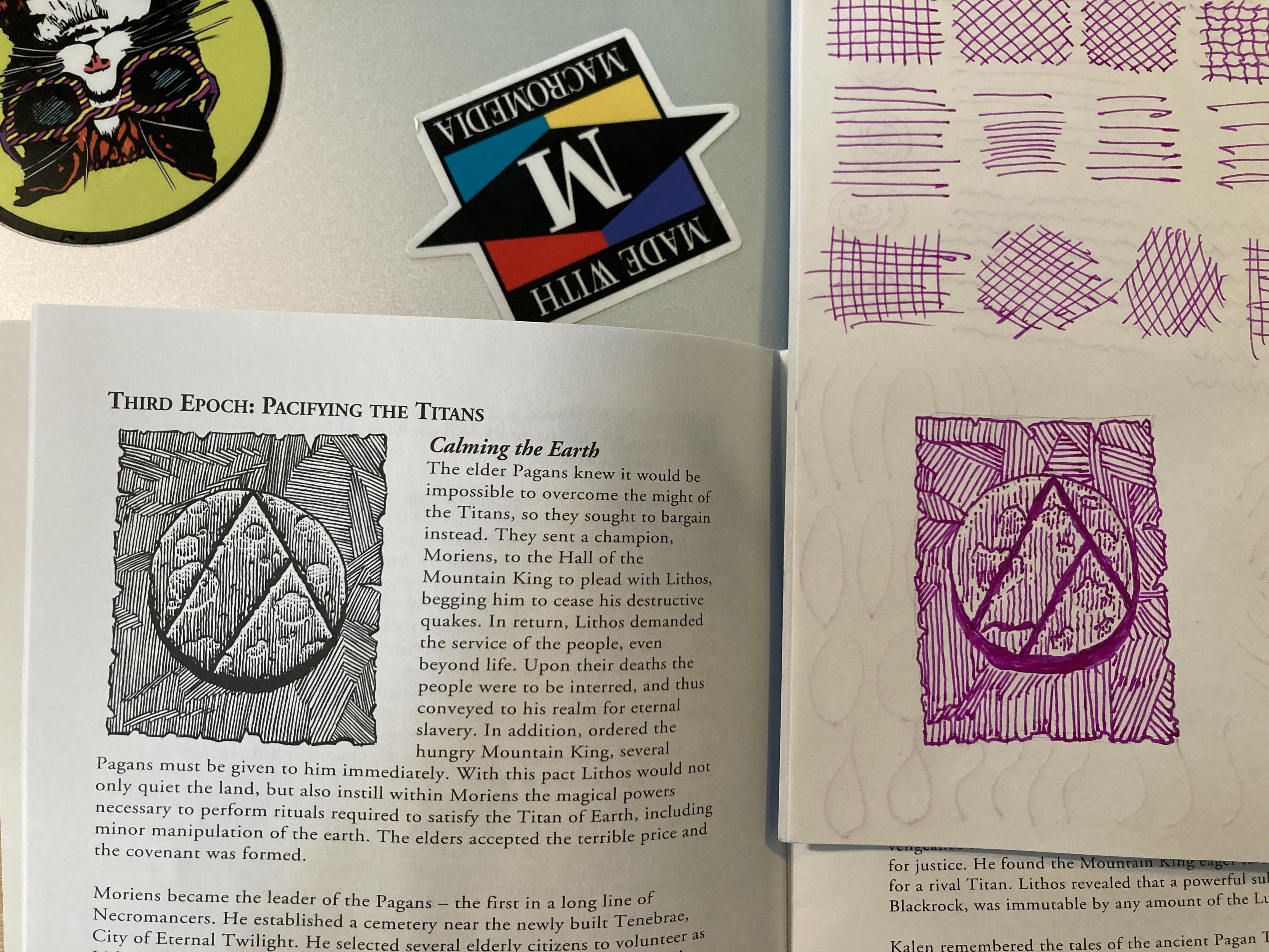 Top left: the outer lid of a laptop.
Top right: some practice lines drawn on a notebook
Bottom left: A page from The Chronicle of Pagan. It shows a parchment sigil, with the symbol of two mountain peaks on it. It is drawn as line-art, with tightly crowded lines to imply texture and greyscale.
Bottom right: the same sigil, redrawn by the author's hand. It is loose, rough, and out of proportion - but looks more or less like the reference.